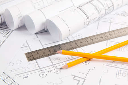 Pencils, ruler and paper engineering house drawings and blueprints.の写真素材