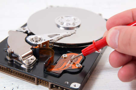Man opening computer hard disk drive (HDD) closeup. Computer Repair conceptの写真素材