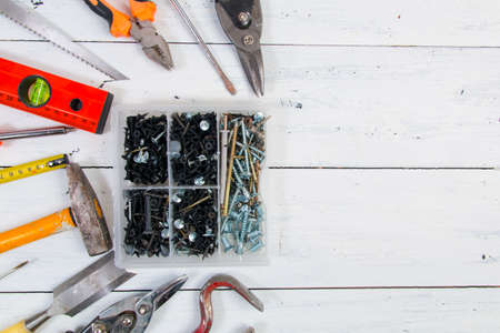 Old hand construction tools on a wooden surface.
