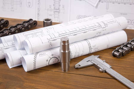 Engineer work. Drawings, measuring tools and details of chains on the table.の写真素材
