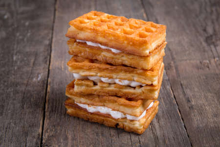 Sweet tasty viennese waffles on wooden table. Breakfast dessert.の写真素材