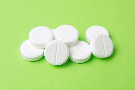 white pills on a green backgroundの写真素材