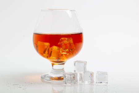 whiskey in glass and ice cube on a white background