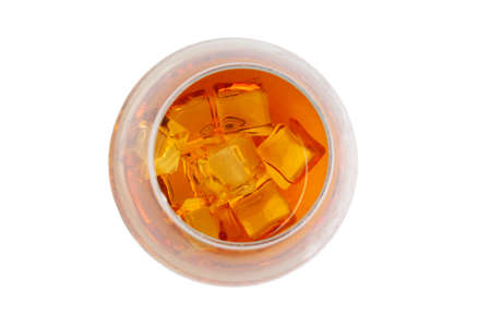 ice cubes in a glass with whiskey. top view on a white background