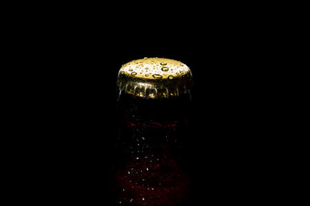 cap of beer bottle closeup on a black backgroundの写真素材