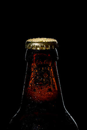 cap of beer bottle closeup on a black backgroundの写真素材