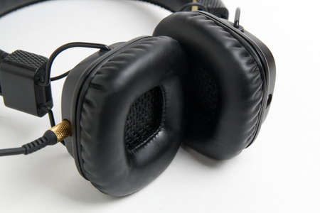 black headphones closeup on white backgroundの写真素材