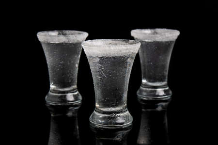 shot of tequila with salt on a black backgroundの写真素材