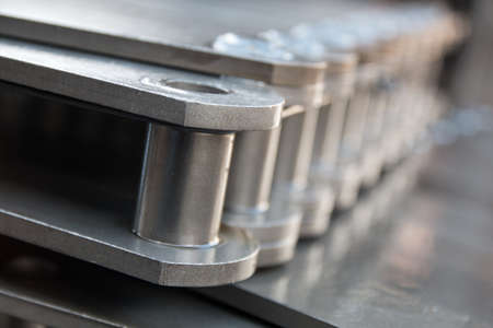 Pulling block conveyor chain close-up. Technology of mechanical engineering.