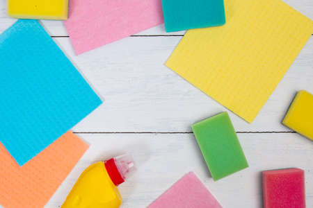 Cleaning concept with copy space. Set of cleaning supplies: sponge, napkin, bottle of liquid...