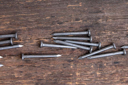 metal nails on wooden backgroundの写真素材