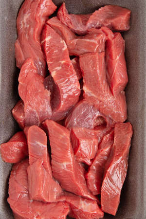 sliced raw meat in plastic box