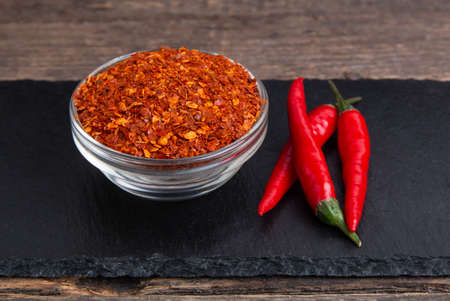 dry ground papper and red chili pepper on wooden table