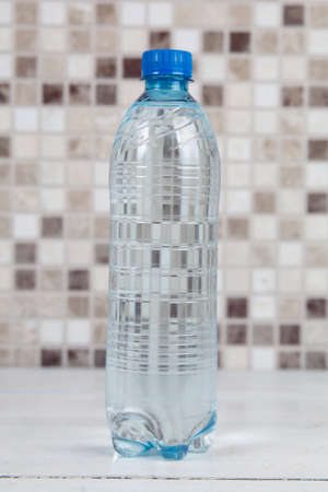 plastic water bottle on kitchen tableの写真素材