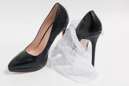 women's high-heeled shoes and panties on white backgroundの写真素材