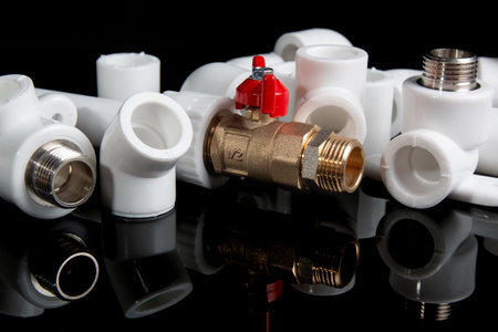 plumbing fittings for plastic pvc pipes and plumbing gate ball vales on black backgroundの写真素材