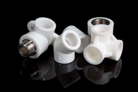 plumbing fittings for plastic pvc pipes on black backgroundの写真素材