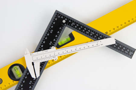 black ruler, building level and caliper on white backgroundの写真素材