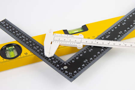 black ruler, building level and caliper on white backgroundの写真素材