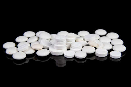 colored medical drugs and pills isolated on black backgroundの写真素材