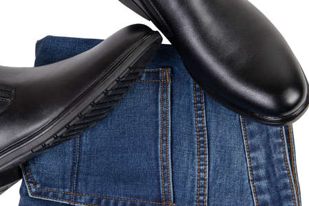 classic black mens shoes and denim jeans isolated on white backgroundの写真素材