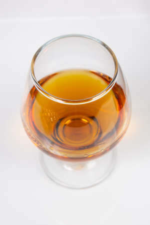 glass with cognac on a white backgroundの写真素材