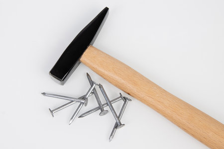 hammer and metal construction nails on a white background.の写真素材