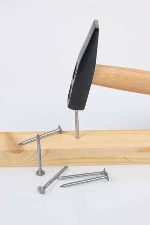 hammer, board and construction nails on white backgroundの写真素材