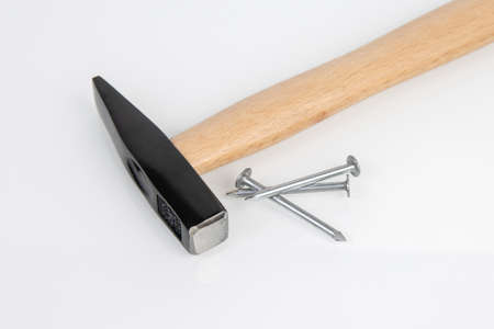 hammer and metal construction nails on a white background.の写真素材