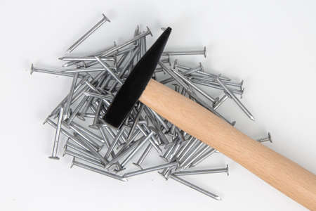 hammer and metal construction nails on a white background.