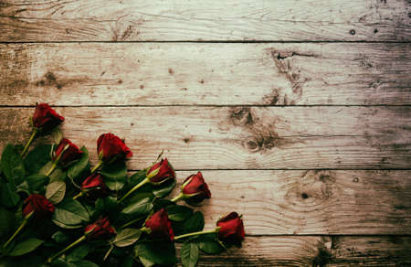 Bunch of roses on wooden background