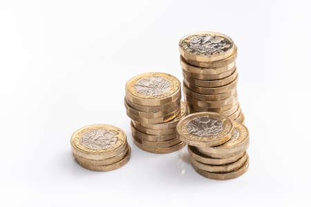 stacks of british pound coins, english moneyの写真素材