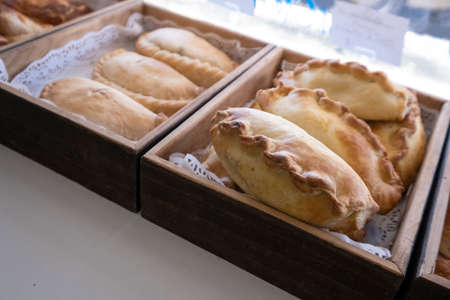 Cornish pasty in bakers shop. A favourite british snack, the pasty is originally from Cornwall and is enjoyed by holidaymakers.の写真素材