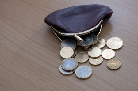 Purse holding lots of euro coins, the currency of the EUの写真素材