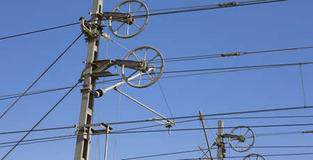 Electrical system of energy transmission to railroad isolated on blue sky