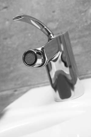 Faucet detail with out of focus background black and whiteの写真素材