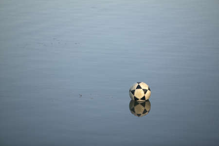 Soccer ball on water in the afternoon horizontalの写真素材