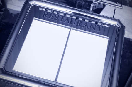 Restaurant menu and guests book copy space toned image on blueの写真素材