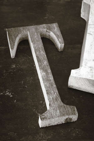 Old printing type font T made from wood vertical black and whiteの写真素材