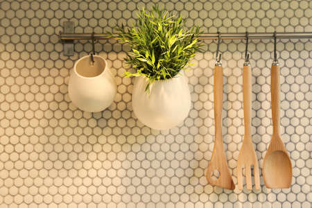 Set of kitchen utensils hanging on wallの写真素材