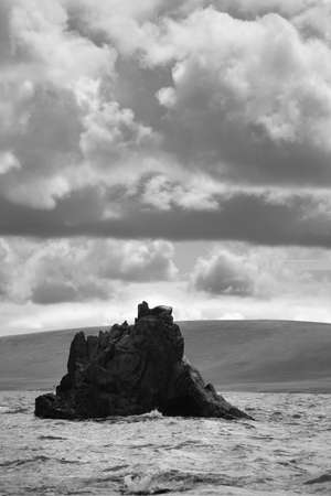 Landscape with rocks, water and dramatic sky at Vatnsnes Peninsula Iceland