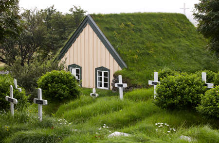 Cemetery and church with peat roof in Southeast area of Icelandの写真素材
