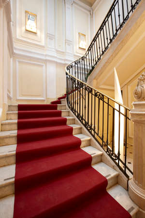 Palace interior with red carpet on a marble stairway のeditorial素材