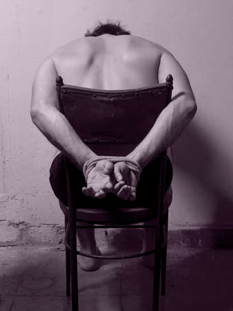 Man with tied hands bi tone vertical imageの写真素材