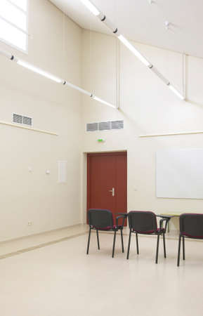 Interior classroom with white walls with chairs  Vertical 