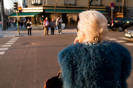 Woman crossing a street at suntet  Horizontal のeditorial素材
