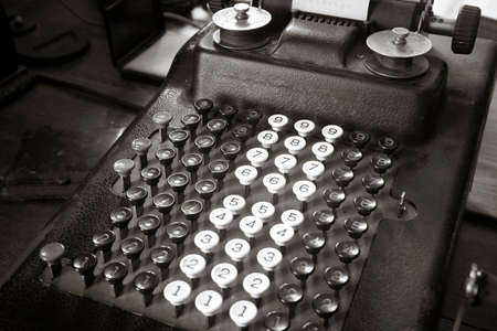 Original antique typewriter calculator in sepia tone  Horizontalの写真素材