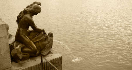 Fountain metallic sculpture and lake in sepia tone  Horizontalの写真素材