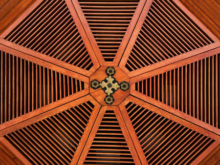 Red wooden structure in a roof with golden parts  Horizontal