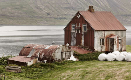 Iceland landscape in Seydisfjordur  Abandoned rusted farm and fiord  Horizontalの写真素材